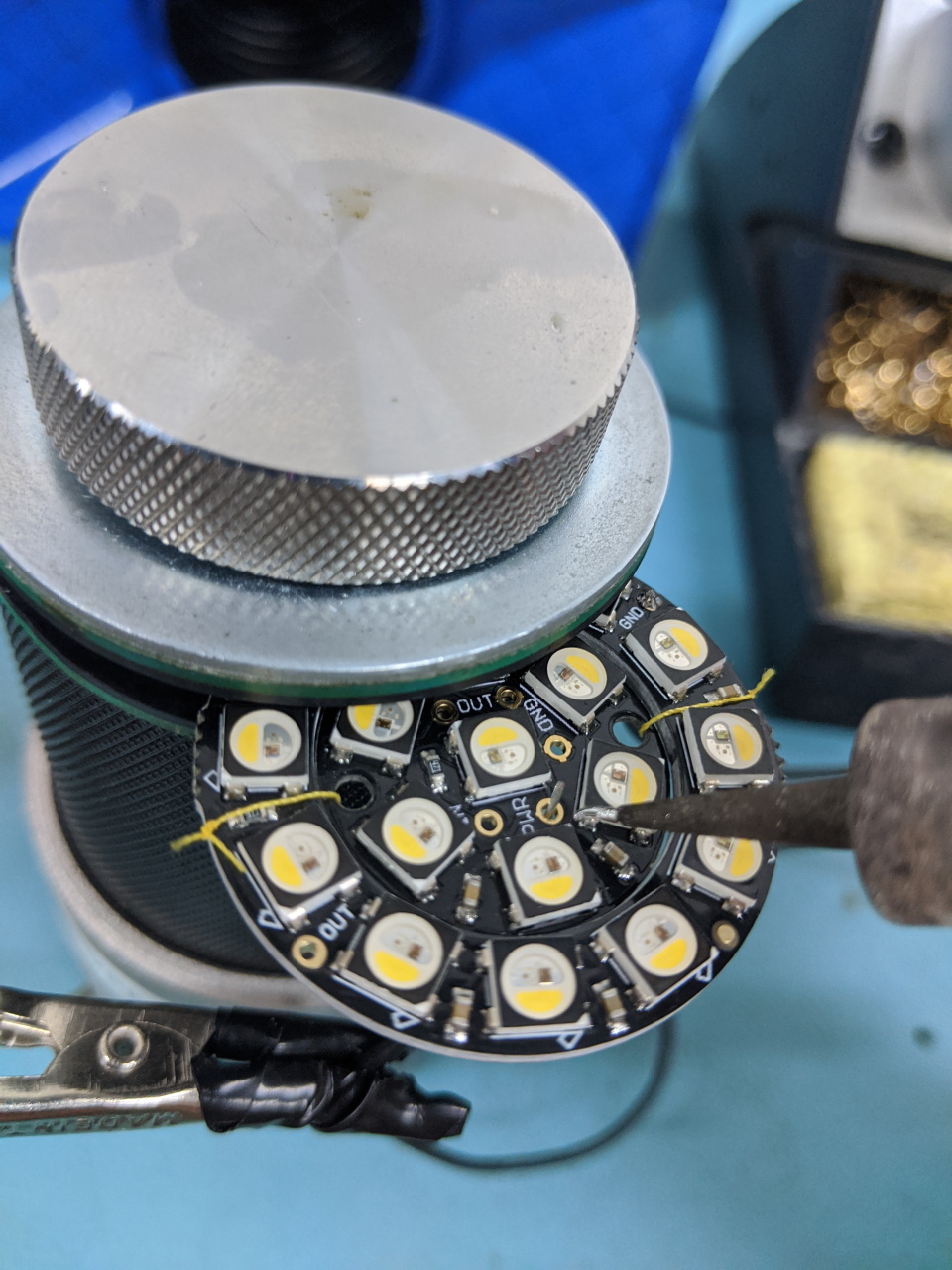 A picture of small LED assemblies being soldered